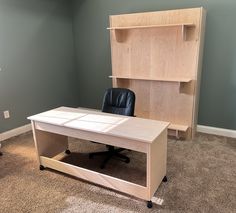 an office desk with a book shelf behind it and a chair in front of it