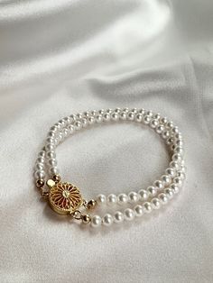 Introducing our delicate "4.5-5mm Freshwater Pearl Double-layer Bracelet," a charming accessory that exudes timeless elegance. Each bracelet is adorned with two layers of lustrous freshwater pearls, ranging from 4.5mm to 5mm in size, creating a dainty and sophisticated look. Pearl type: Freshwater pearl Pearl size: 4.5-5mm Colour: White Length: 17cm Findings: 18K gold planted over S925 sterling silver FREE SHIPPING on all orders Exchange only within 14 days of delivery. Elegant Multi-strand Layering Bracelets, Elegant Multi-strand Bracelets For Layering, Elegant Multi-strand Adjustable Pearl Bracelet, Elegant Adjustable Multi-strand Pearl Bracelet, Multi-strand Pearl Bracelets As Gift, Adjustable Double Strand Pearl Necklace, Elegant Multi-strand Beaded Bracelets For Gifts, Elegant Round Beads Bracelets For Layering, Elegant Double Strand Gold Pearl Bracelet