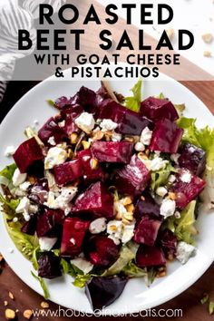 roasted beet salad with goat cheese and pistachios on a white plate