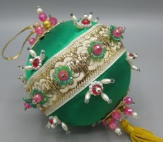 an ornament with beads and flowers on it