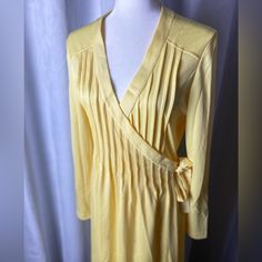 Circa 1970s Wrap Dress. 100% Poly. Beautiful Pin Tuck Pleats. Long Sleeves. Below Knee Length. Soft Yellow Color. There Are A Couple Of Faint Stains I Will Try To Launder Out. Vintage Wrap Dress, Soft Yellow, Pin Tucks, Dress 100, Yellow Color, Wrap Dress, Knee Length, 1970s, Midi Dress