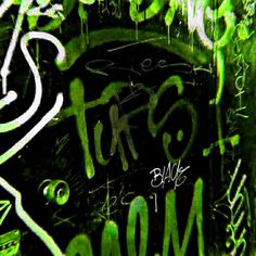 graffiti written on the side of a building in green and black colors with white writing