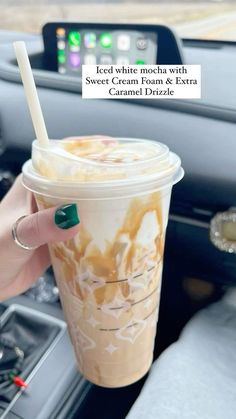 a woman is holding a cup of ice cream and caramel drizzle in her hand