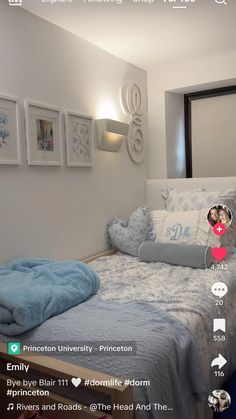 an image of a bedroom with pictures on the wall and bed in the room,