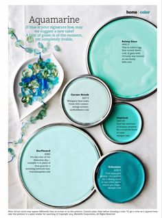 four aquamarine plates sitting on top of a white tablecloth with blue and green accents