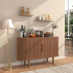 a wooden cabinet sitting next to a lamp on top of a hard wood floored floor