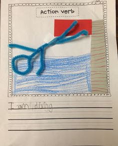 a piece of paper that has scissors on it and the word action verb written in blue yarn