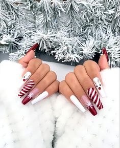 a woman's hands with red and white christmas nails