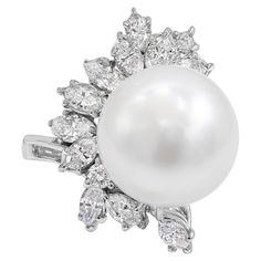 An elegant pearl and diamonds cocktail ring features a 14.50mm white south sea pearl, accented by a cluster of mixed-shape diamonds weighing 2.37 carats total. Made in 18K White Gold. Style available in different price ranges. Prices are based on your selection. Please contact us for more information. Luxury White Cluster Pearl Ring, Pearl Cocktail Ring, Diamond Bracelet Design, Pearl Rings, Vintage Cocktail Ring, Bridal Diamond Jewellery, Diamond Cocktail Ring, Pearl And Diamond Ring, Pearl Cluster