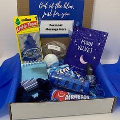 a box filled with personal care items on top of a blue cloth covered tablecloth