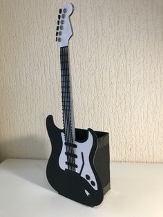 a black and white guitar shaped object sitting on top of a table