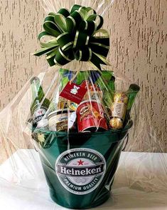 a green bucket filled with beer and snacks