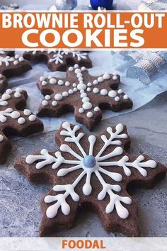 brownie roll - out cookies with white frosting and snowflakes on them