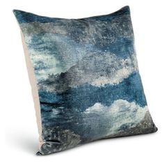 a blue and white pillow with clouds on it's side, in front of a white background