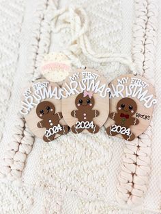 three wooden buttons with gingerbreads on them and the words merry christmas, happy new year