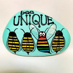 painted rock with three bees and the words bee unique on it