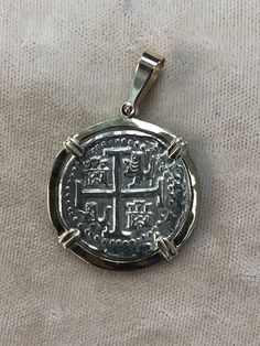 This silver Atocha coin is made from the silver bars that was recovered from the Nuestra Senora de Atocha. It comes with a certificate stating that. The bail and bezel are solid 14KT gold. Own a piece of history! Tarnish Resistant Sterling Silver Coin Amulet Necklace, Spiritual Nickel-free Coin Pendant Necklace, Authentic Atocha Coin Necklace, Silver Sterling Silver Coin Necklace, Tarnish Resistant, Antique Nickel-free Silver Coin Necklace, Key West Fl, Silver Bars, Key West, 14kt Gold