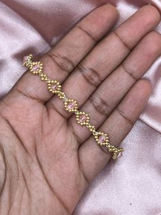 Elevate your style with our Gold Tennis Bracelet! Handmade using gold seed beads and a stunning bicone bead, it adds a touch of elegance to any outfit. Choose from a variety of colors for the perfect accessory. Make a statement with our versatile and luxurious bracelet. (45 words)