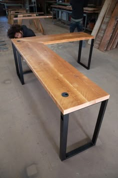 a wooden bench sitting on top of a metal frame in a room filled with furniture