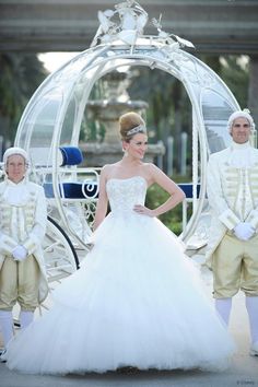 a woman in a wedding dress standing next to two men