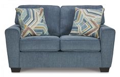 a blue couch with two pillows on it