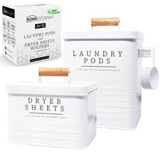 two white containers with wooden handles and labels for laundry pods in front of the box