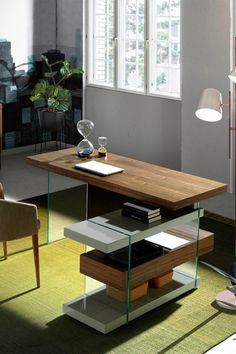 a living room filled with furniture and a table in front of a window on top of a rug