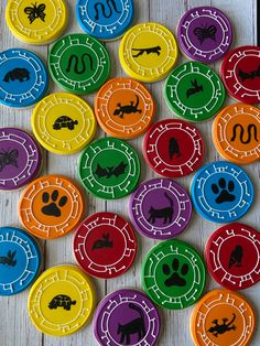 many different colored buttons with animals on them