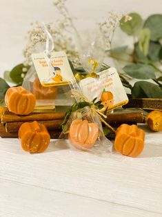 some kind of soap sitting on top of a wooden table next to leaves and flowers