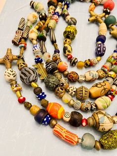 You will receive:   Assorted ethnic African & global beads. Random shapes and size-Mix rainbow colors recycled glass, ceramic, beads, African Brass, Bone beads. Cause they are totally handmade they are not perfect on shape and colors Please see all the pictures Beads are mixed RANDOMLY in no pattern. No two strands are exactly the same. amazing handmade beads, you'll love them! Material: Glass, Brass, Bone, resin Size: from 2-50mm Approximately   hole: 1-3mm Sold by strand 14" each Approximately Artisan Large Recycled Glass Beads, Multicolor Recycled Glass Beads For Jewelry Making, Multicolor Recycled Glass Jewelry For Jewelry Making, Multicolor Recycled Glass Bead Jewelry, Multicolor Recycled Glass Beaded Jewelry, Fair Trade Multicolor Round Bead Jewelry, Artisan Beaded Necklaces For Festivals, Colorful Recycled Glass Beaded Necklaces, Recycled Glass Beaded Necklaces With Colorful Round Beads