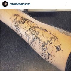 a man's arm with a world map tattoo on it