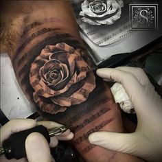 a man with a tattoo on his arm is getting ready to cover up the rose