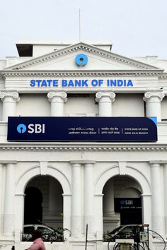 the state bank of india building is white with blue letters on it's front