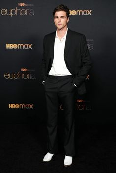 a man in a black suit and white shirt