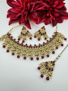 This is a beautiful Polki/Reverse AD Mehndi polish Maroon/Dark red Semi-bridal necklace set with matching long earrings and Tika has amazing shine. This is so beautiful to look at and a perfect one for Indian weddings.  Color : gold, Maroon/Red Necklace length : collar necklace length Necklace width :  Earring length : 2.5 inch Earring width : 1.75 inch Each Earring Weight: 12.8 Grams Material : Brass, Reverse AD, pearls Beautiful High Quality, premium jewelry. Free US standard shipping. Hand cr Eid Kundan Jewelry Sets As Gift, Eid Jewelry Sets With Latkans As A Gift, Eid Gift Jewelry Sets With Latkans, Bollywood Style Intricate Design Gift Sets, Bollywood Style Gift Sets With Intricate Design, Kundan Bridal Sets For Eid Gift, Eid Gift Kundan Bridal Sets, Eid Bridal Earrings With Tilla For Gift, Bollywood Bridal Sets With Stone Work For Gifts