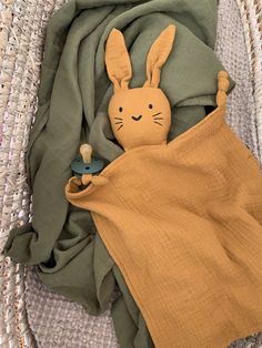 a stuffed animal is wrapped in a blanket