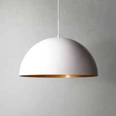 a white and gold light hanging from a ceiling