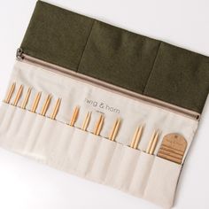 the zippered pouch is filled with different types of knitting needles