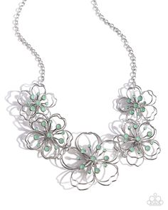 Shiny silver wire delicately twists into layered blossoms with light green opalescent rhinestone floral centers. Varying in size, the airy floral frames delicately link into an asymmetrical display as the layered frames elegantly pop beneath the collar. Features an adjustable clasp closure. Sold as one individual necklace. Includes one pair of matching earrings. Layered Frames, Collar Verde, Floral Frames, Wooden Bracelet, Hair Accessories Gift, Seed Bead Necklace, Blue Necklace, Green Necklace, Rhinestone Necklace