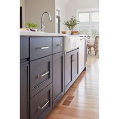 a kitchen with gray cabinets and white counter tops is pictured in this image from the front view