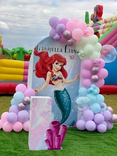 an inflatable balloon arch with ariel the mermaid on it and balloons surrounding it