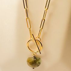 A golden link necklace is always a bold yet classic look and Mona necklace looks amazing with a collared shirt or even a basic T-shirt. Here, we've added some extra flair with an easy to close toggle clasp in the front. Then, extra detail with a specialty cut labradorite in an arc shape. The Labradorite Gem is a dark green/gray with flashes of iridescence. ⬩8-12mm Semi-Circle shape Labradorite⬩18-inch Gold Plated Toggle necklace⬩Labradorite is a stone of transformation and magic This item will s Toggle Necklace, Toggle Clasp, Jewelry Card, Circle Shape, Link Necklace, Classic Looks, Labradorite, Green And Grey, Jewelry Box