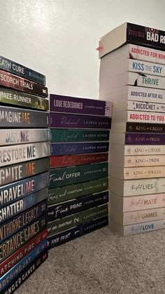 a stack of books sitting on top of a carpeted floor next to each other