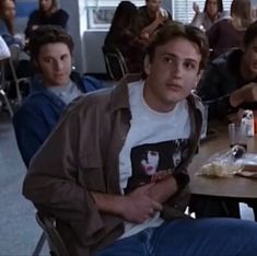 a group of people sitting around a table with drinks and food in front of them