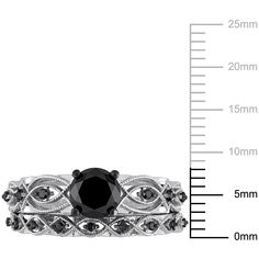 a black diamond ring is shown in front of a measuring line with the measurements for it