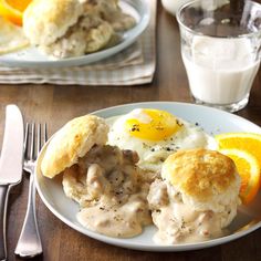 biscuits and sausage gravy on a white plate with an egg in the middle