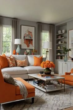 a living room filled with furniture and lots of orange flowers on top of a coffee table