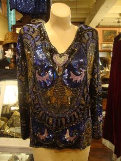 This is a vintage beaded and sequined top by Jean for Joseph Le Bon.  It's silk with multicolors of blues, black, purples and golds and a few more!  This top is entirely covered and heavy!  So beautiful!   No tears, rips, odors.  Perfect for parties and the Holidays!  Comes from a smoke free home.Measurements:  Bust:  38"   Waist:  38"   Hip:  40"   Across Shoulder:  15.5"   Sleeve Length:  23.5"   Length from Shoulder to Front Hem:  26" Please ask me any questions you may have before buying as Purple Bohemian Top For Party, Purple Bohemian Party Tops, Heavy Winter Coat, Top Jean, Sequined Top, Full Skirt Dress, Evening Tops, Club Tops, Brown Silk