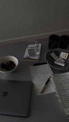 an apple laptop computer sitting on top of a desk next to a cup of coffee