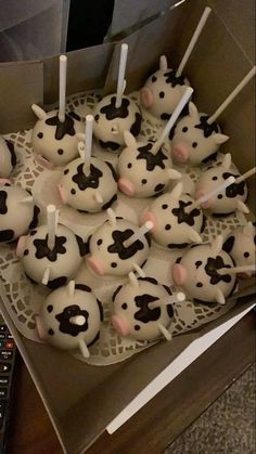 a box filled with cupcakes covered in frosting and decorated to look like cows